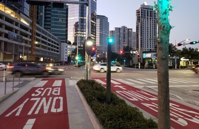 Cars driving showing the MetroRapid Silver Line Route in red that say bus only.